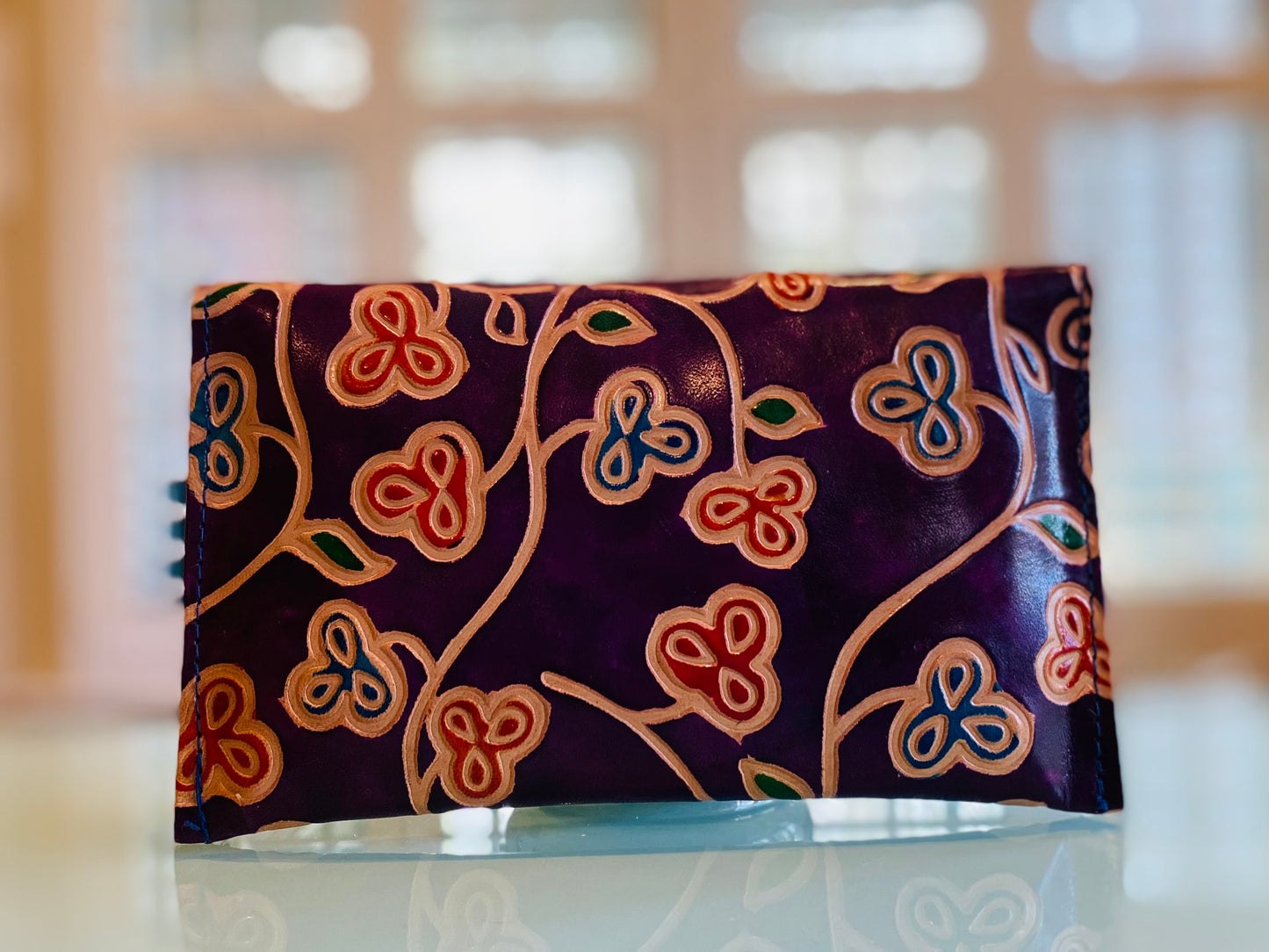 LEATHER WALLET FLOWERS ON EGGPLANT COLORED BACKGROUND