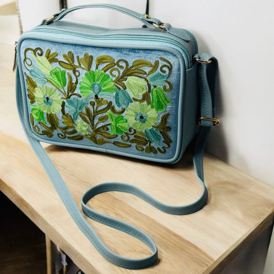 LEATHER SLING BAG & PURSE WITH VELVET BACKGROUND;  BLUE VELVET BACKGROUND WITH LIGHT KHAKI AND GREEN FLOWERS