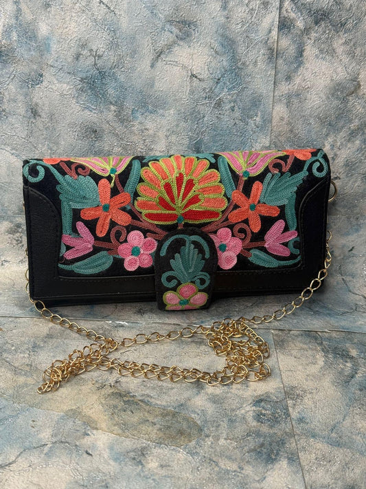 LEATHER WALLET WITH EMBROIDERY; BLACK WITH HUES OF RED BLUE AND RUST